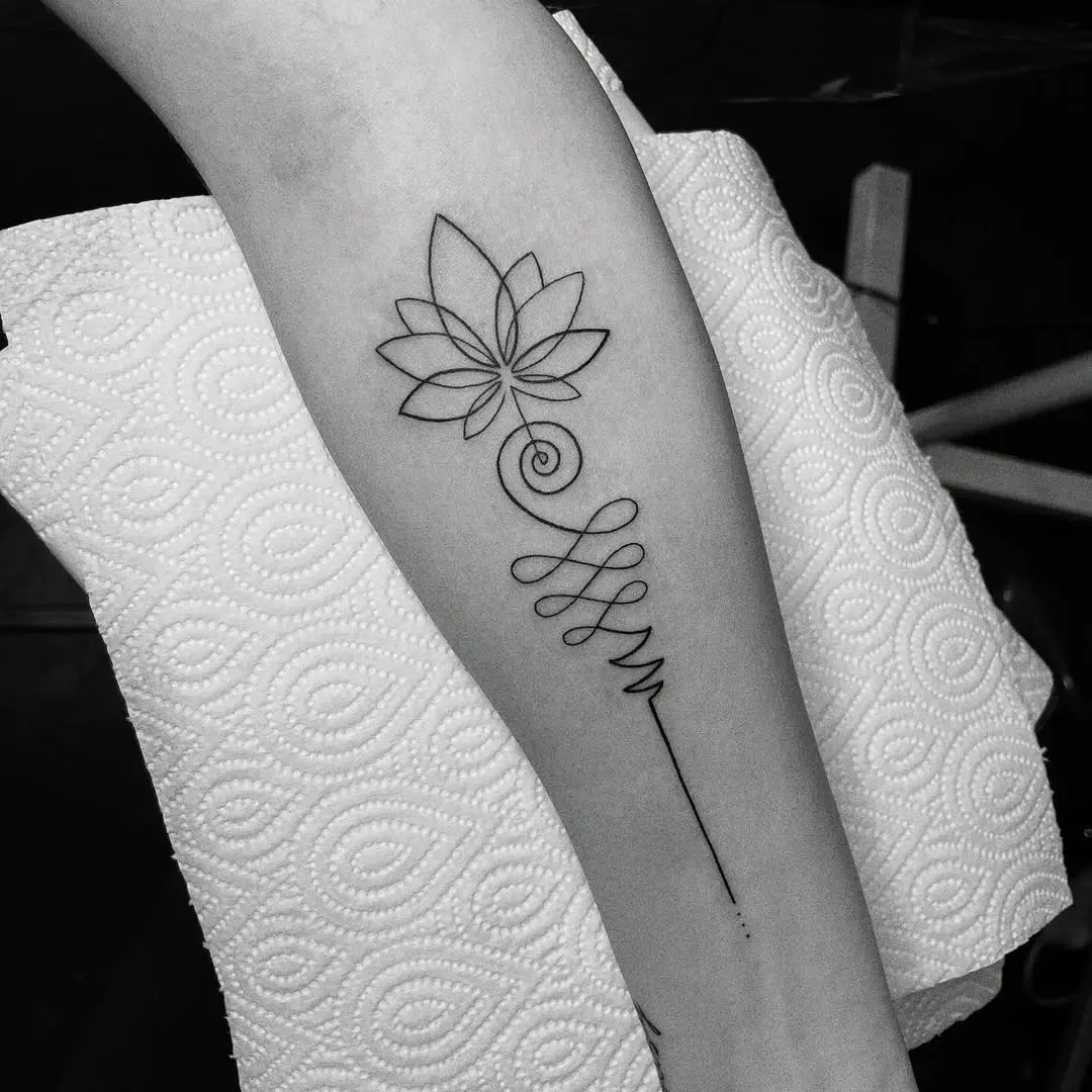 Minimalist lotus tattoo with elegant swirls