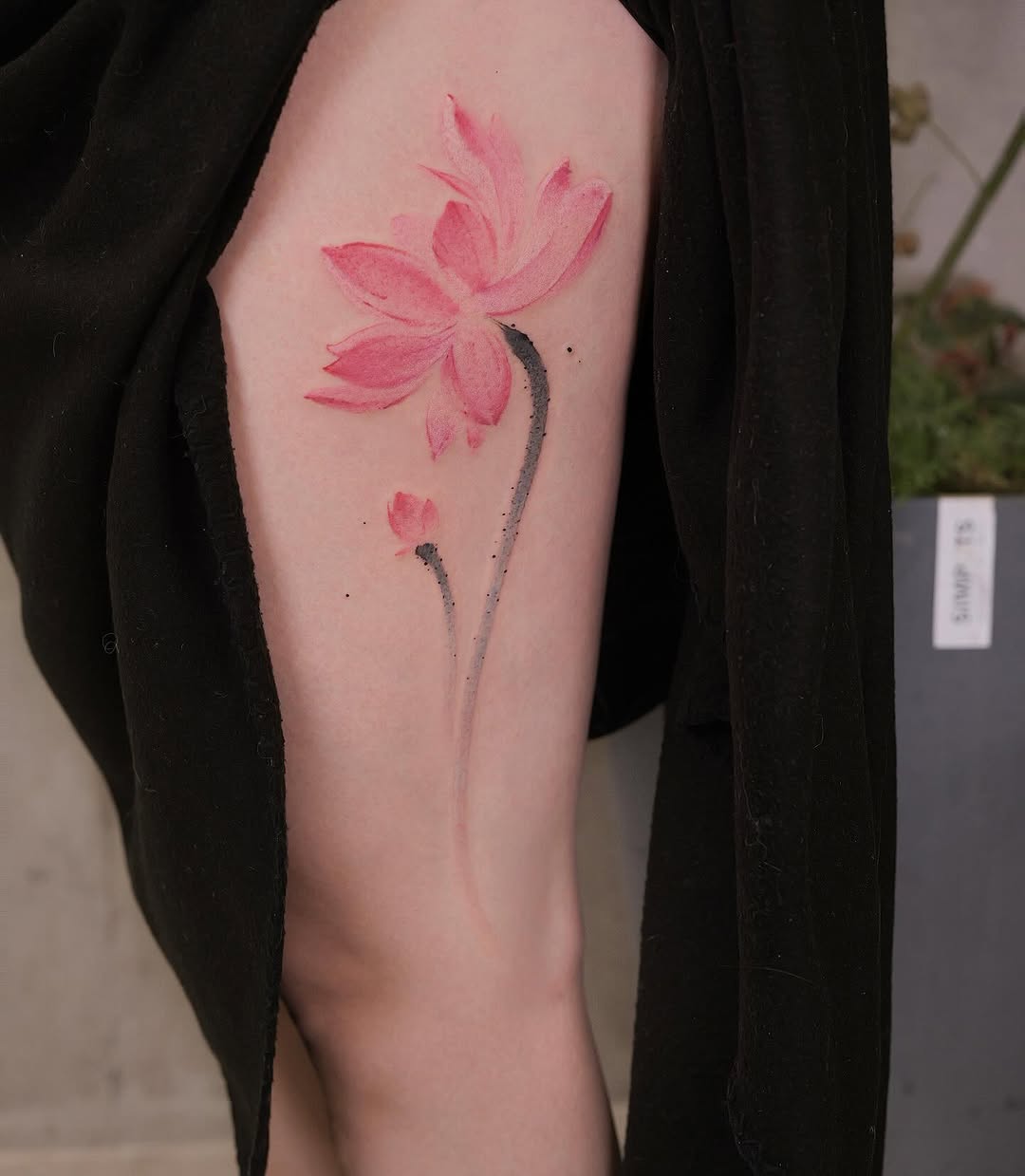 Elegant pink lotus tattoo on thigh area