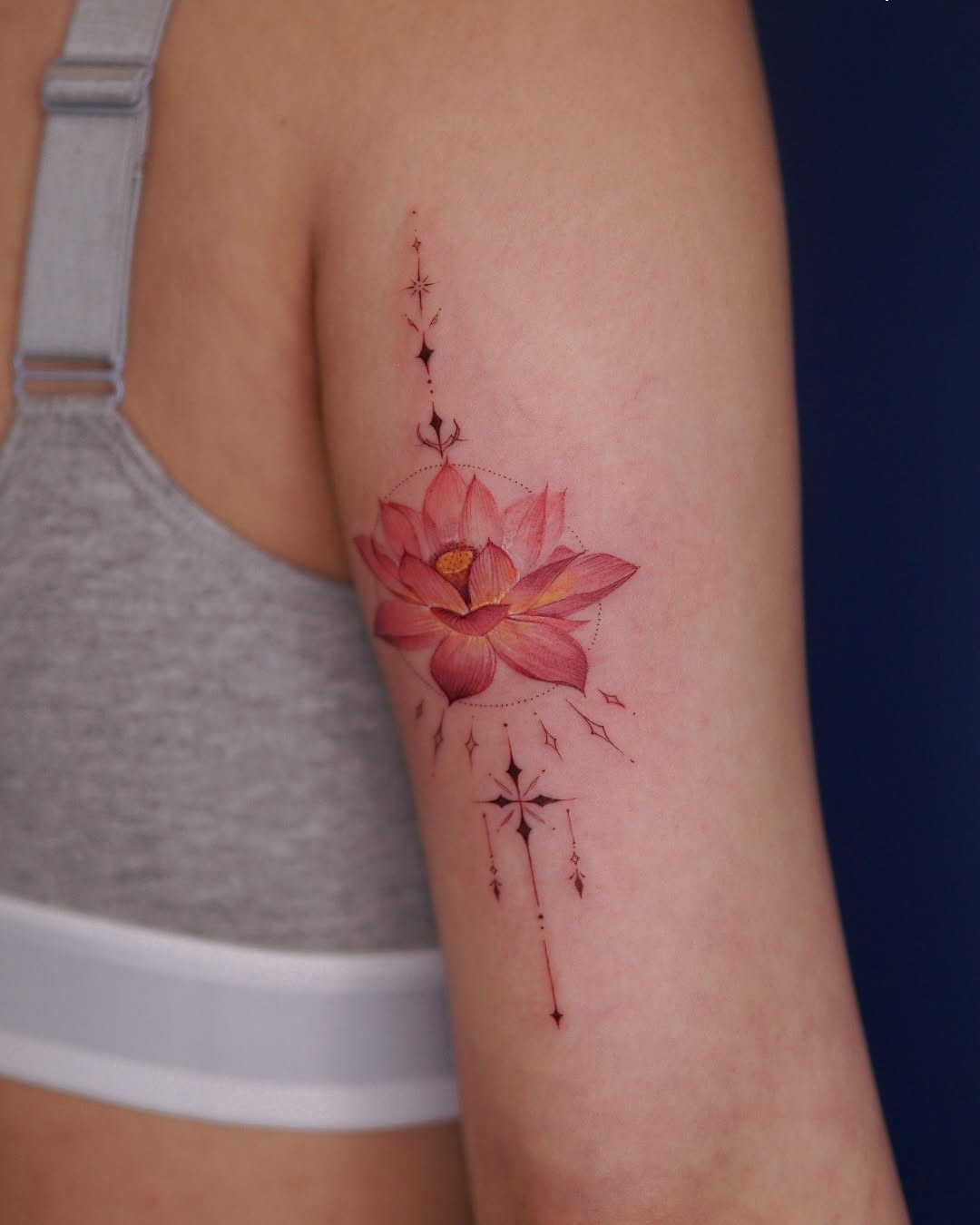 Vibrant lotus tattoo with delicate detailing