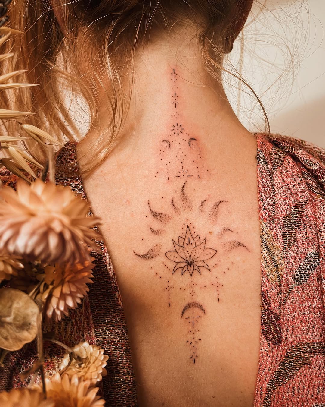 Elegant Back Lotus Tattoo With Mystical Elements