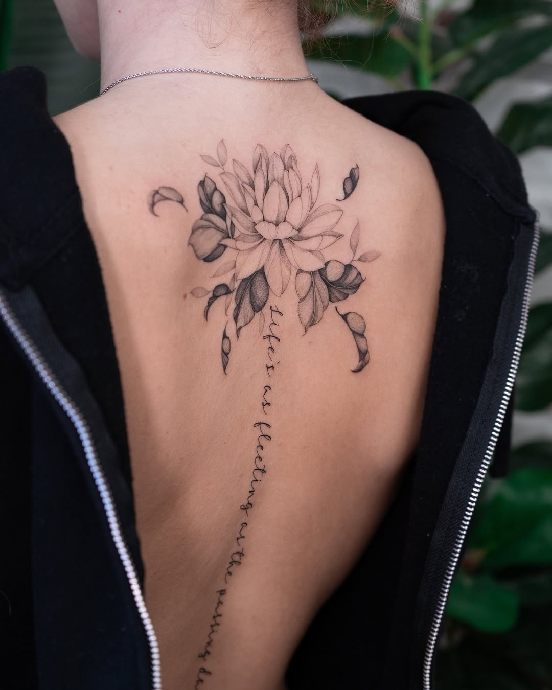 Elegant lotus tattoo with delicate floral details.