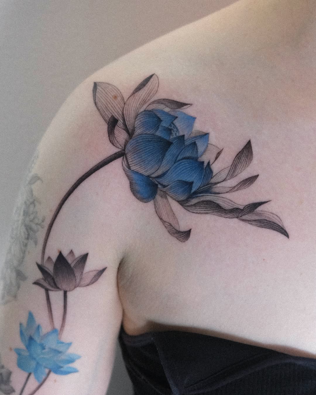 Stunning blue lotus tattoo with delicate details