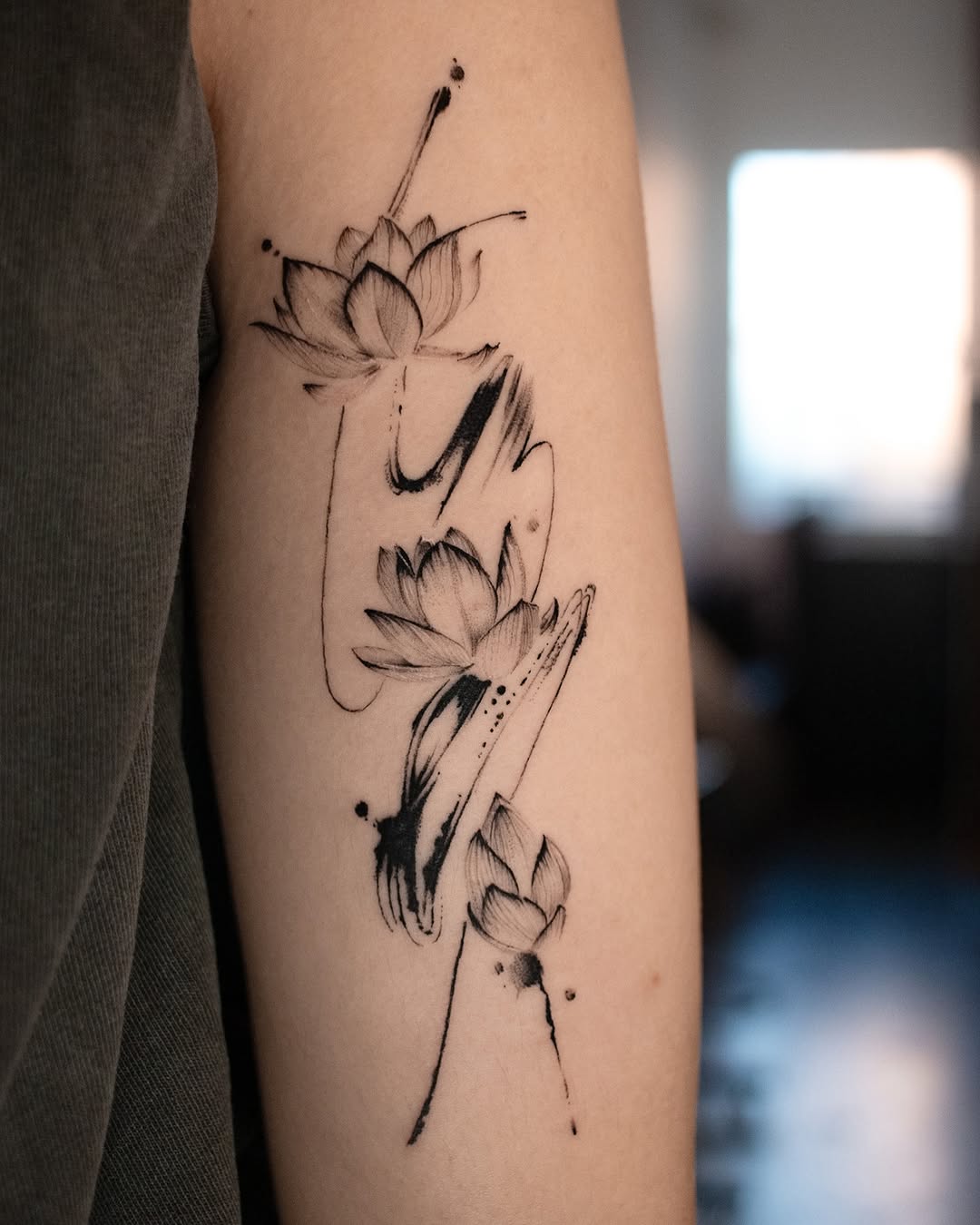 Elegant lotus tattoo with flowing black lines