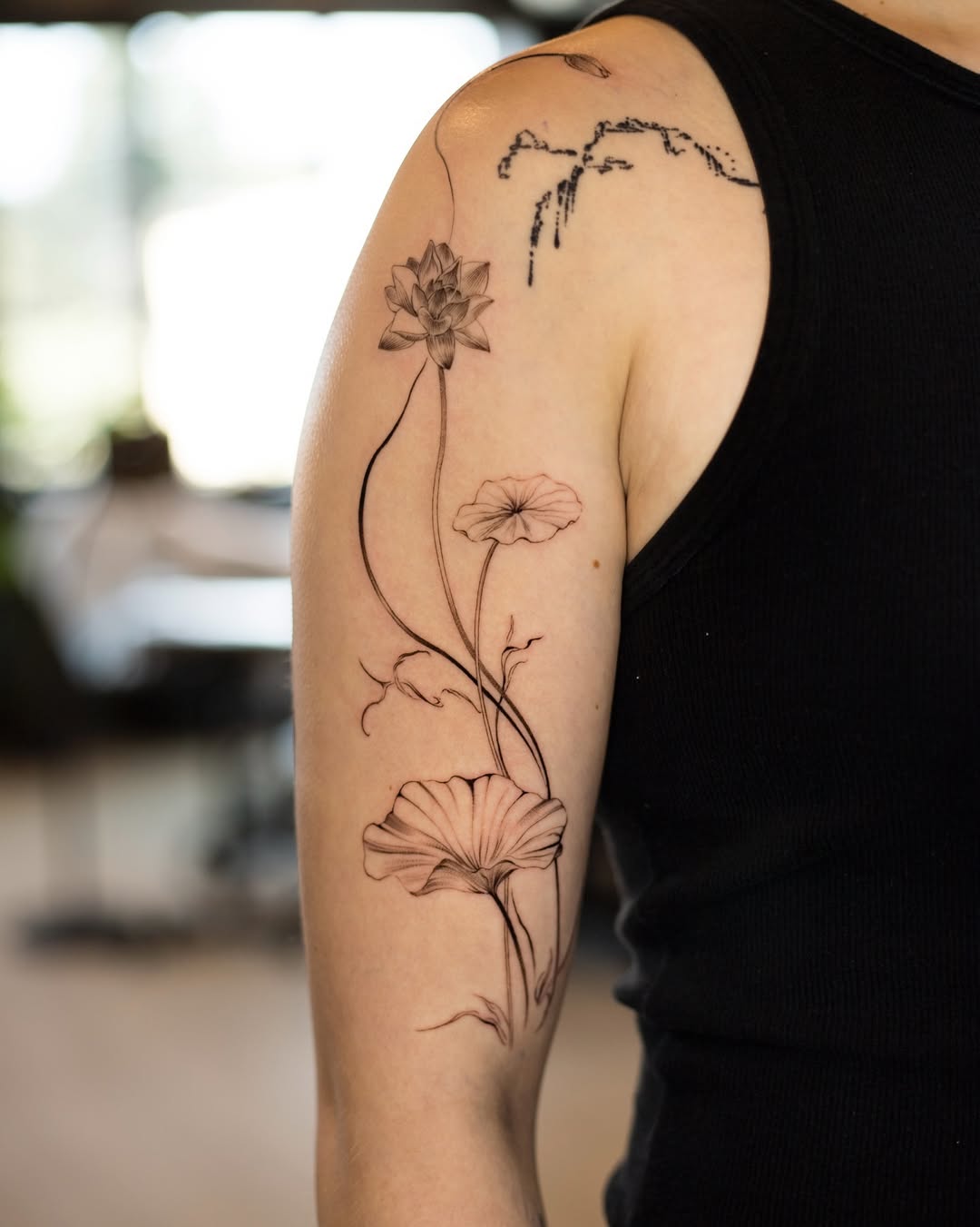 Elegant floral lotus tattoo on the arm