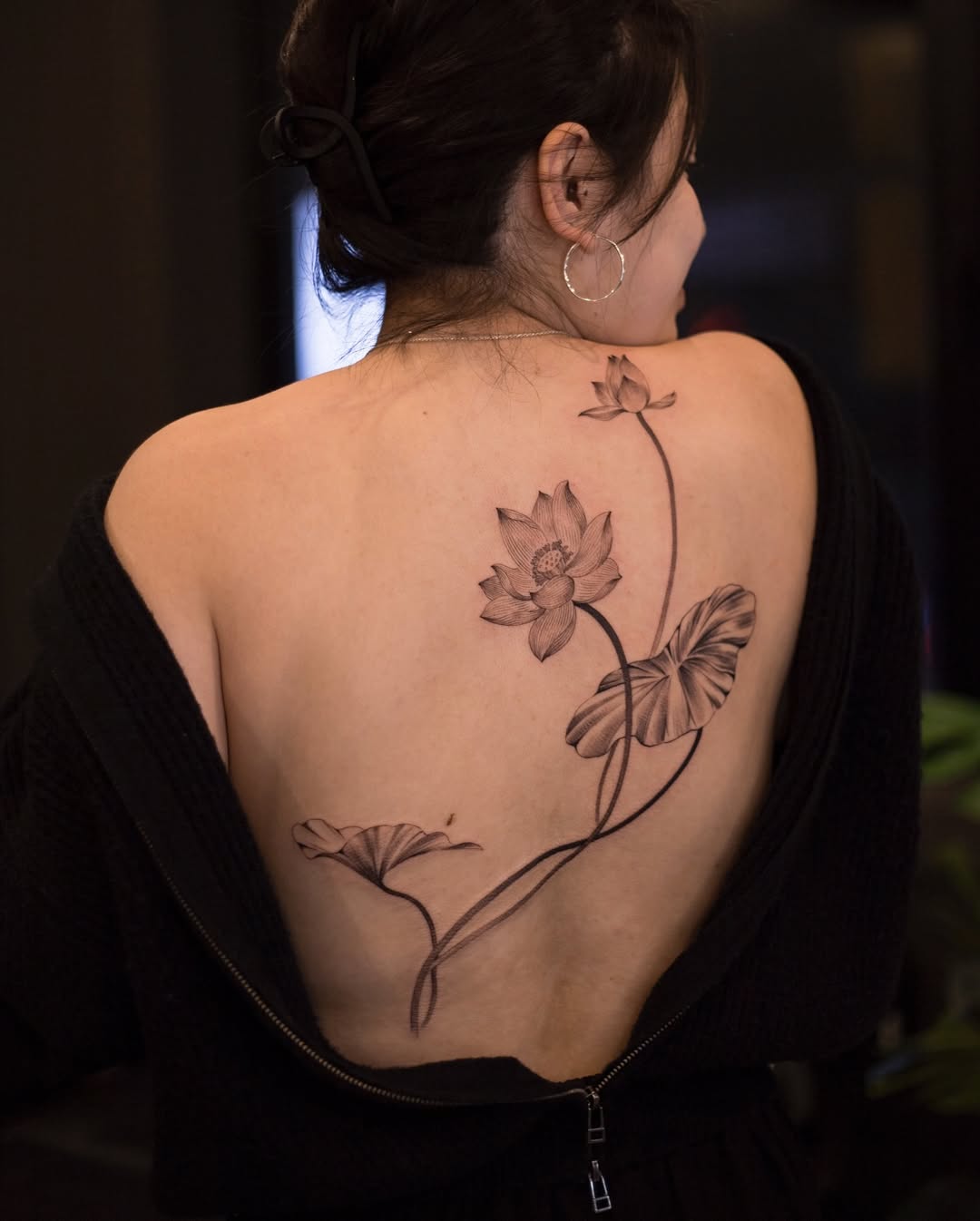 Elegant Lotus Tattoo Gracefully Adorning the Back