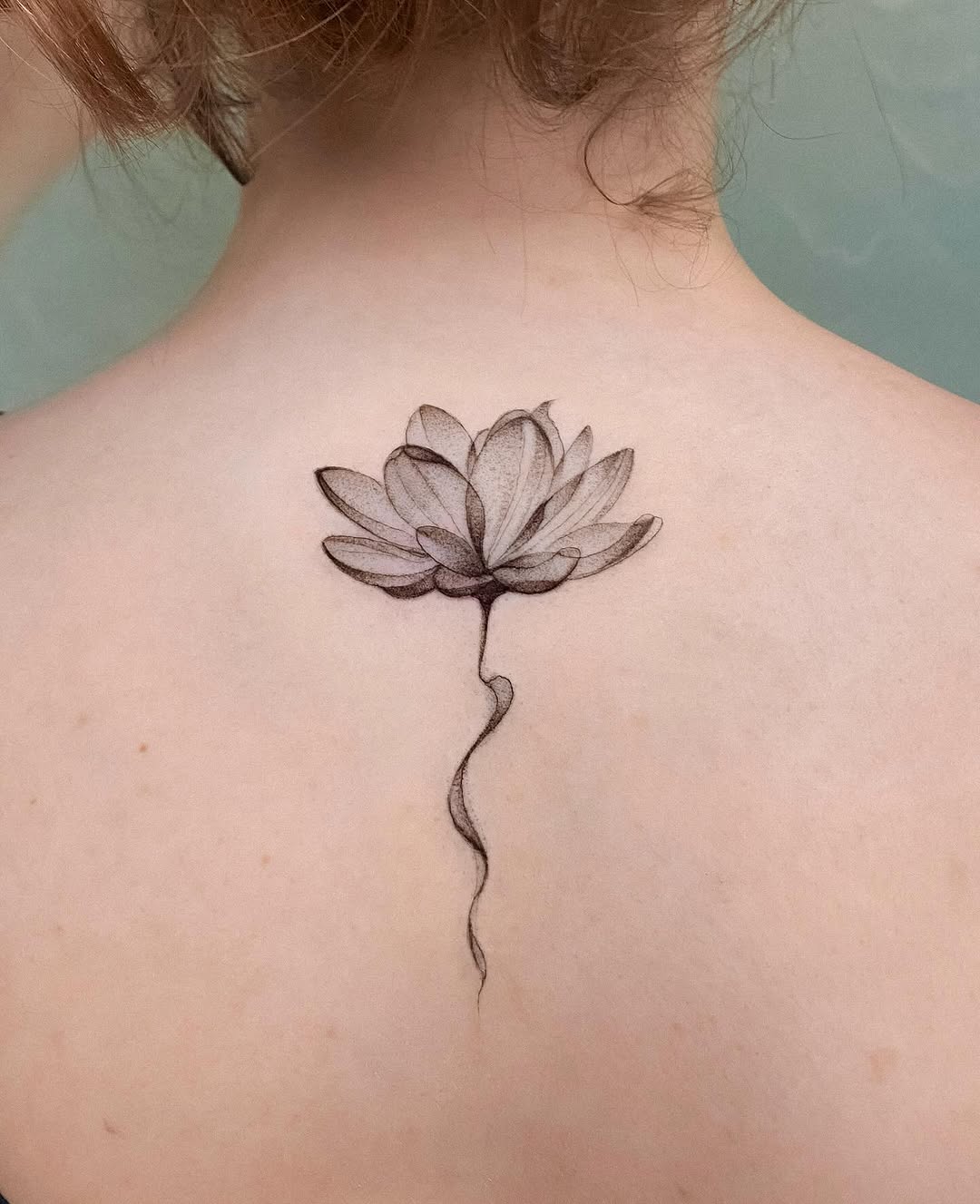 Elegant lotus tattoo with delicate detailing