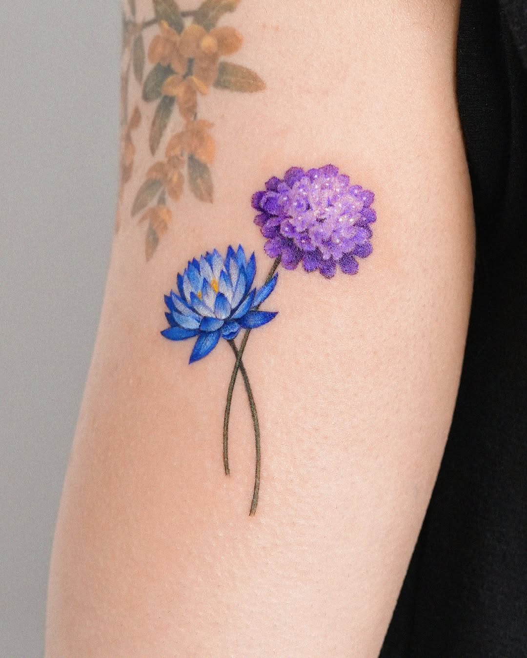 Vibrant blue and purple lotus flower tattoo