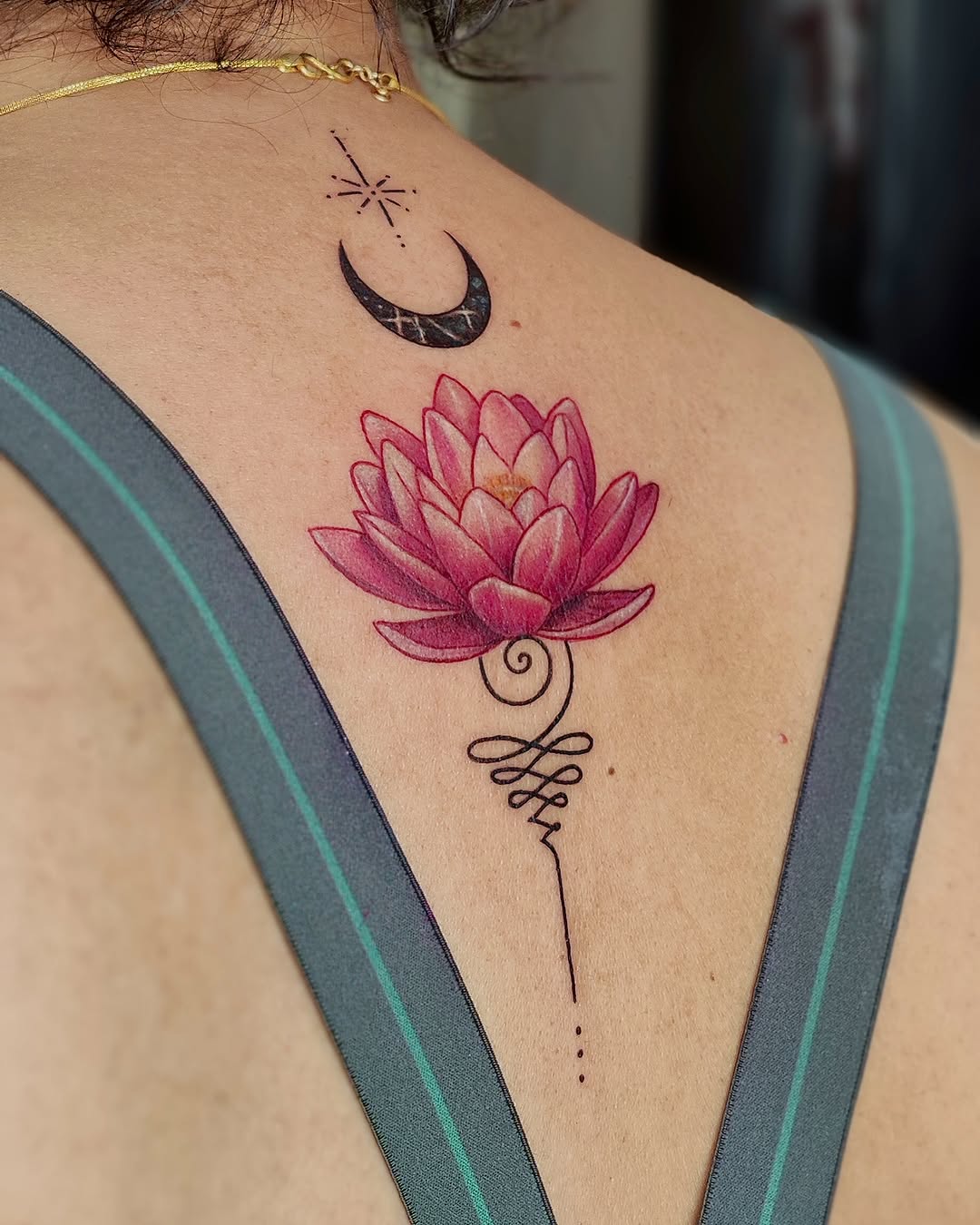 Elegant lotus tattoo with moon accent