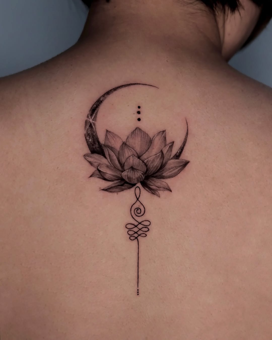 Elegant lotus tattoo with moon and line art