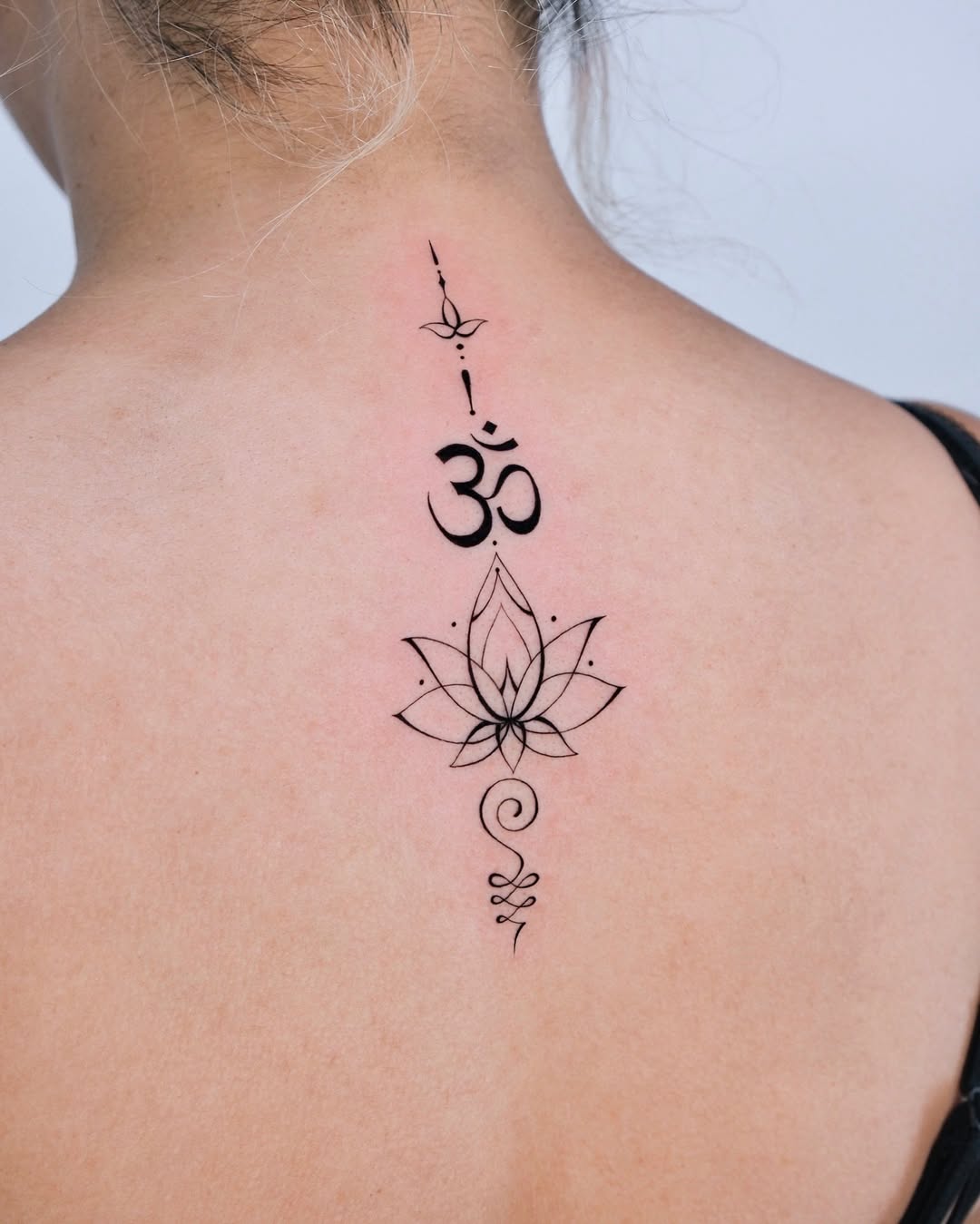 Stylish lotus tattoo with spiritual symbols