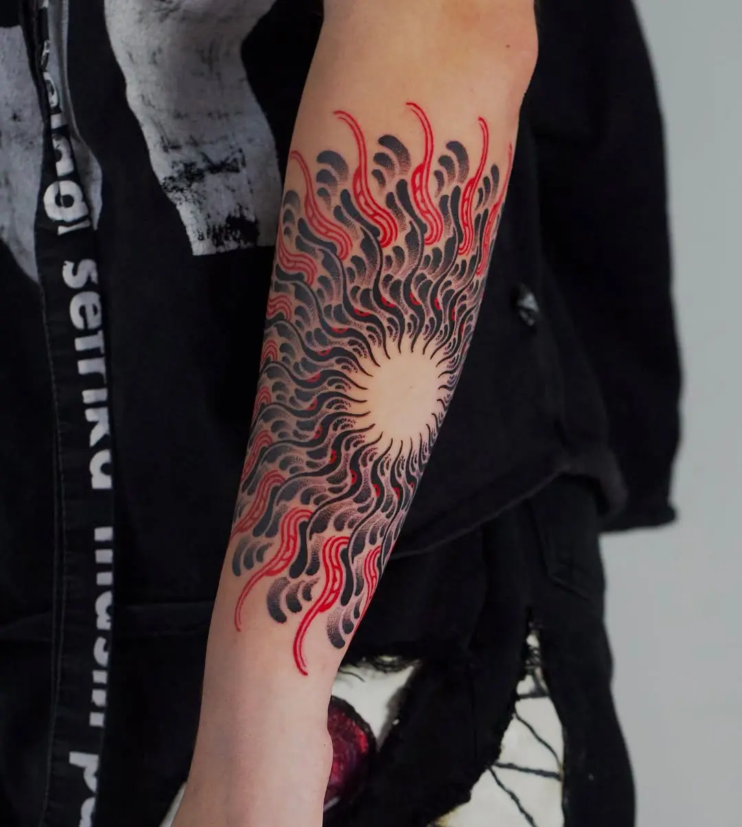 Dynamic sunburst mandala tattoo on forearm