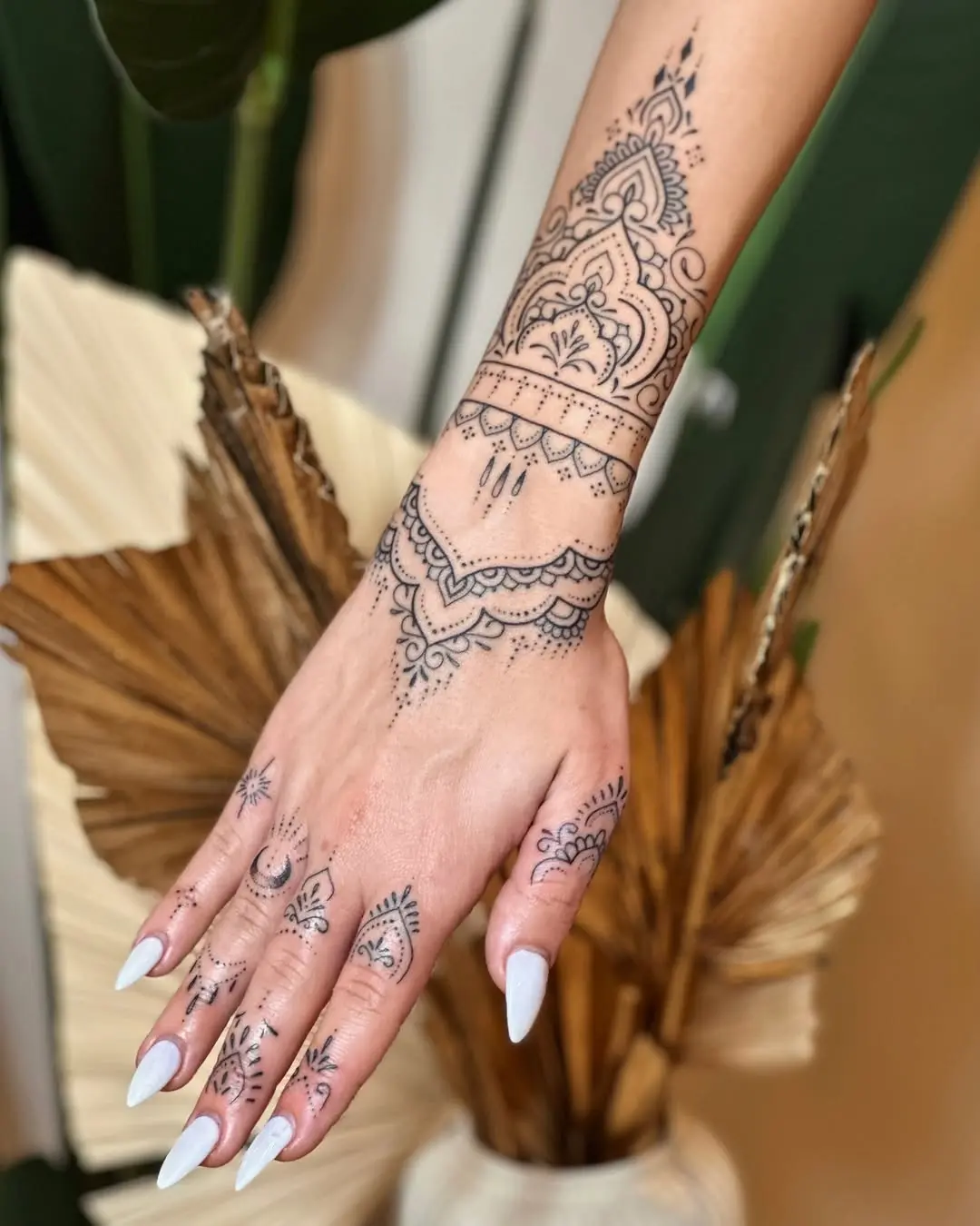 Elegant mandala tattoo adorning the hand