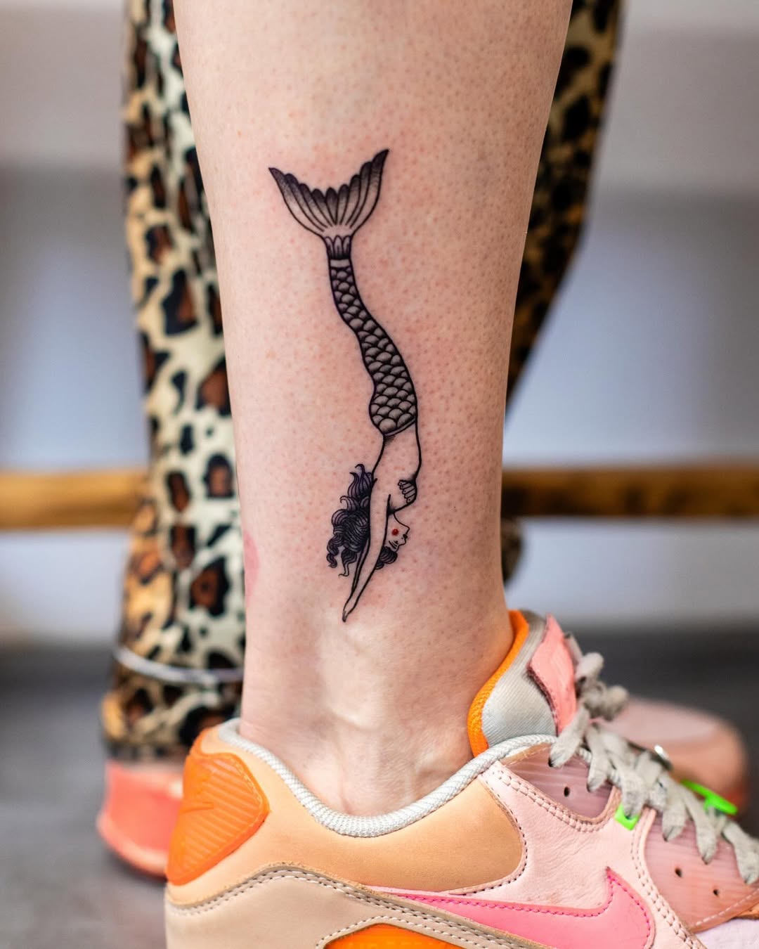 Elegant mermaid tattoo diving into the ocean