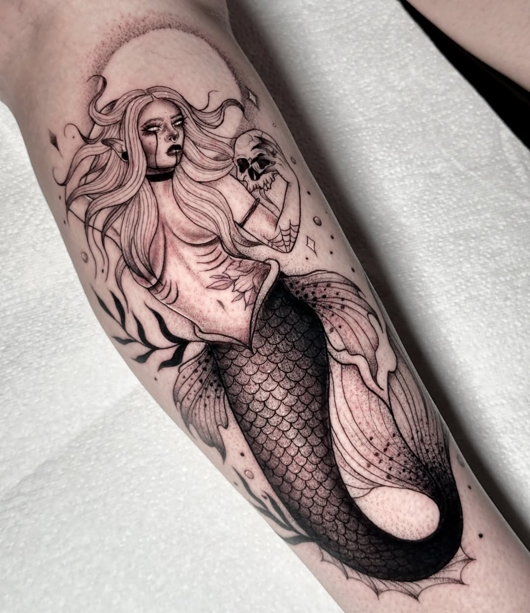 Intricate mermaid tattoo with a mystical vibe