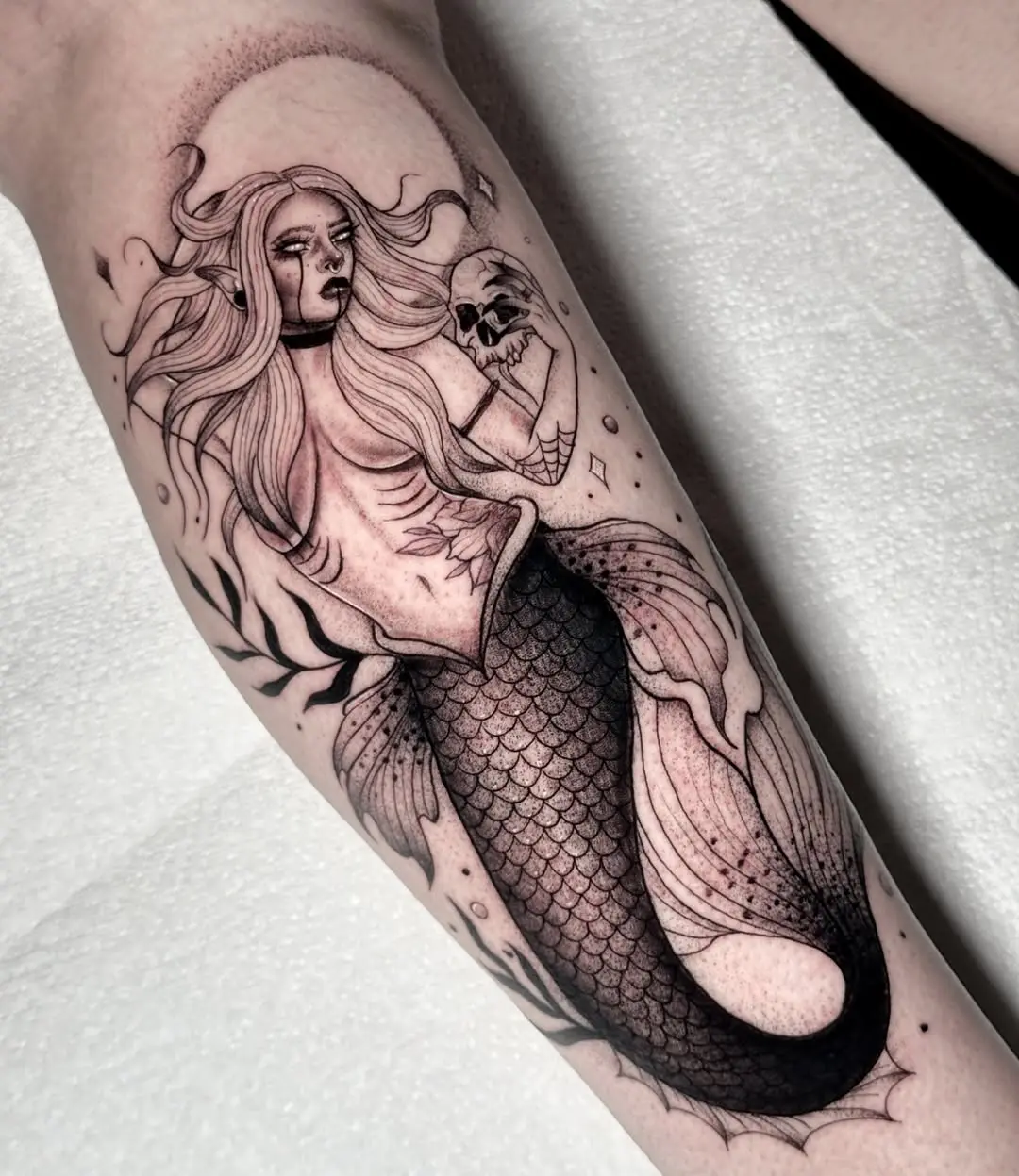 Intricate mermaid tattoo with a mystical vibe