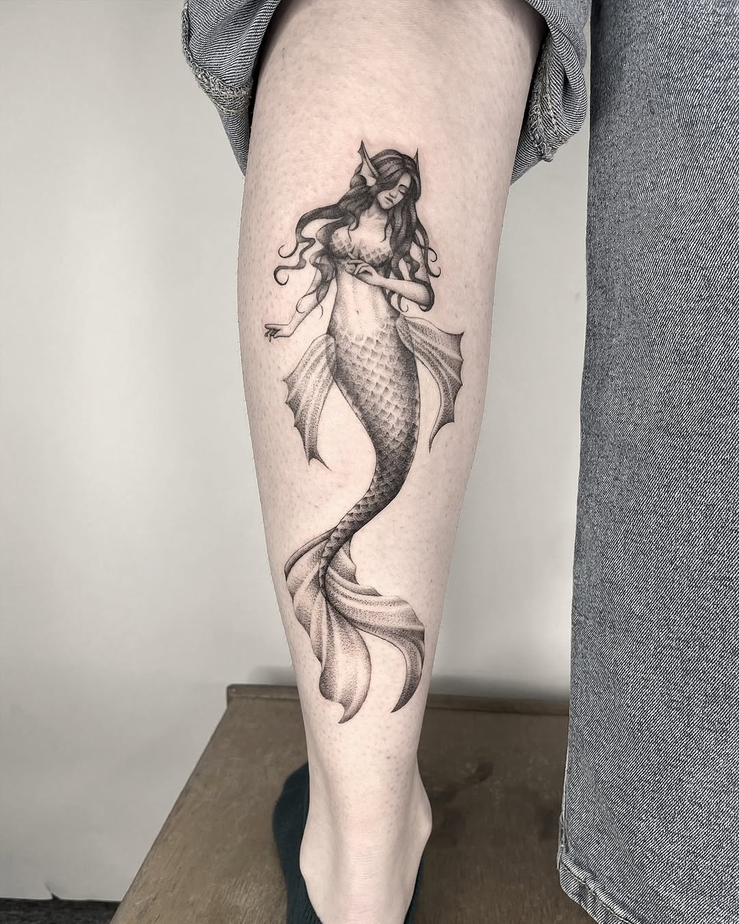 Elegant mermaid tattoo on a leg