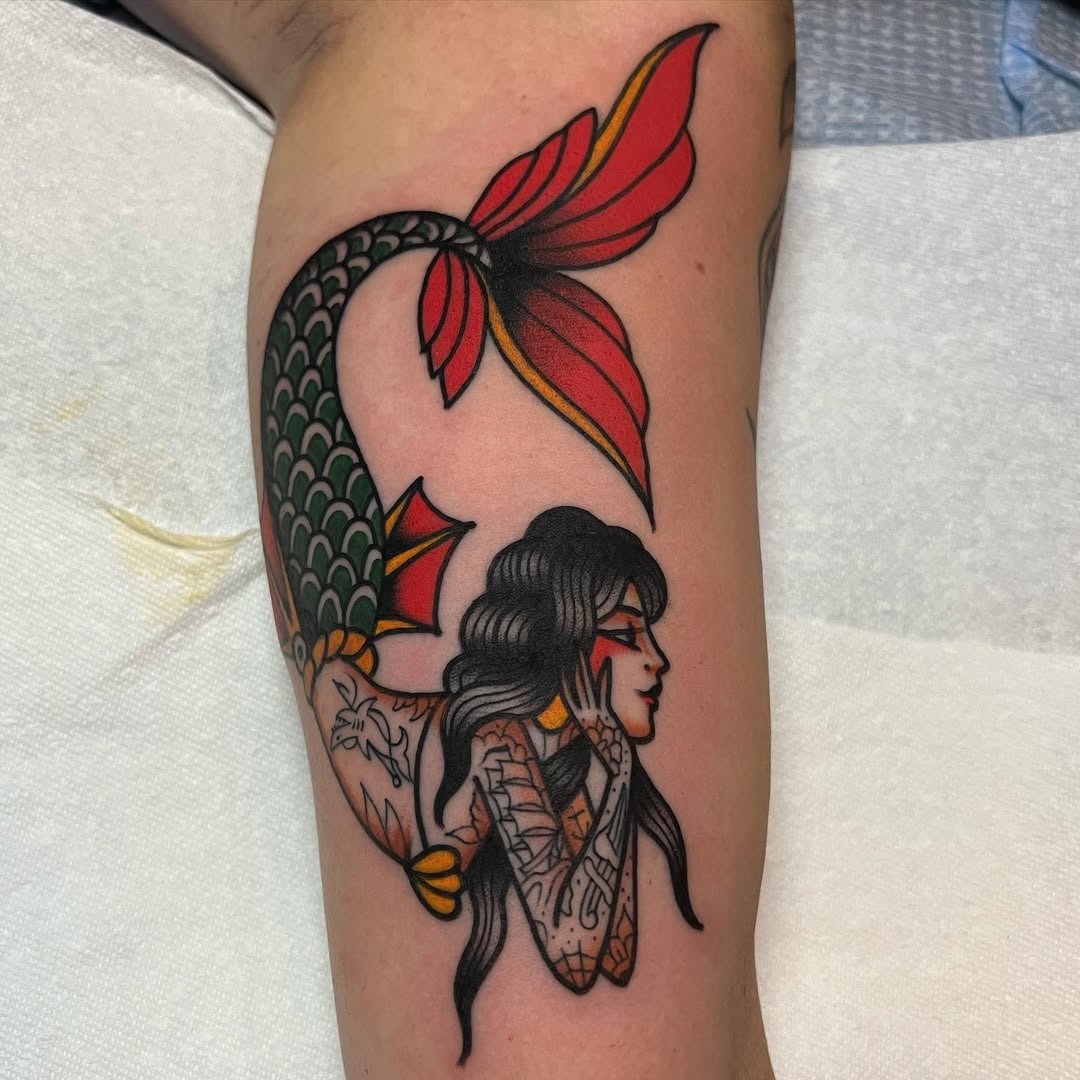 Vibrant mermaid tattoo showcasing fantasy and nature.
