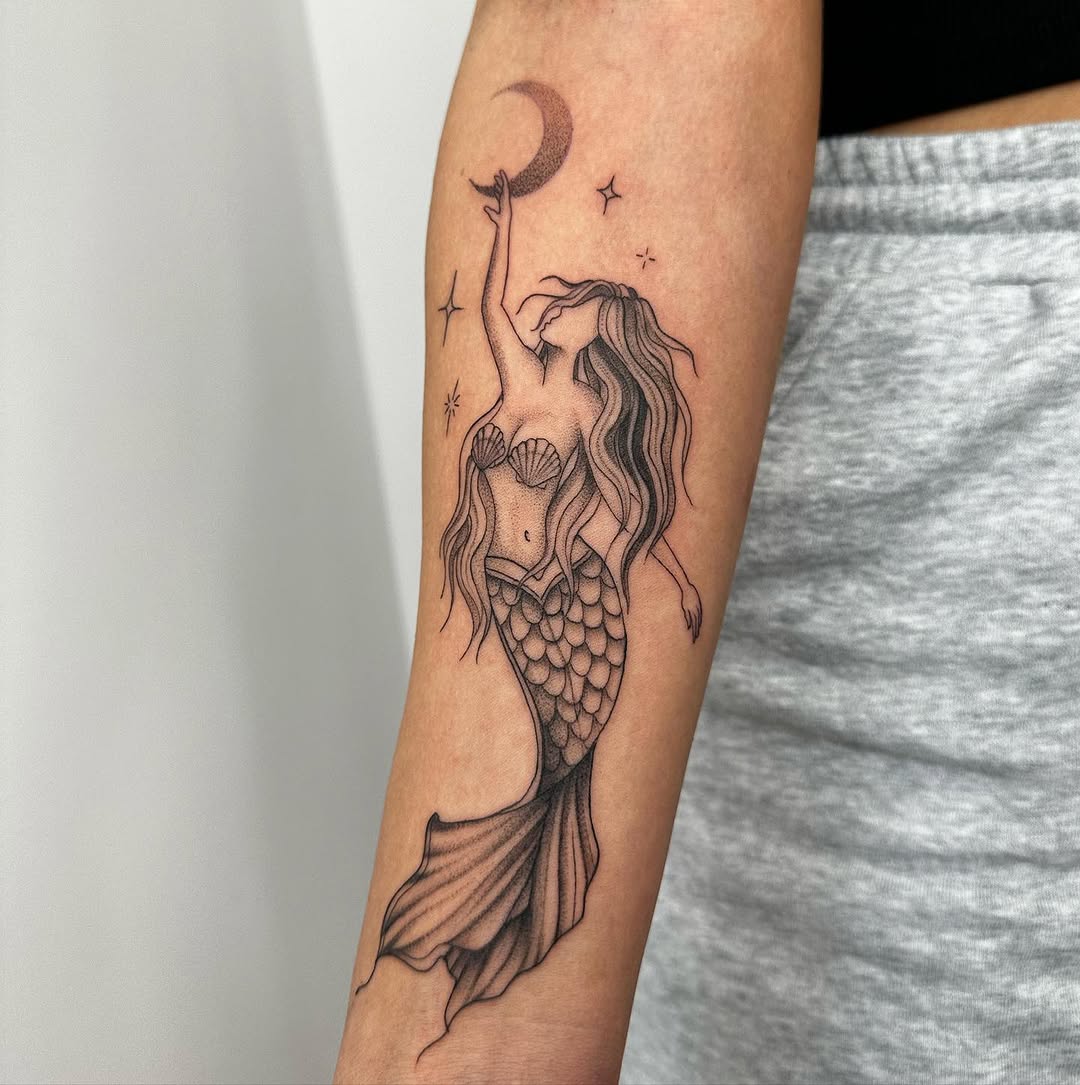 Enchanting mermaid tattoo with celestial elements