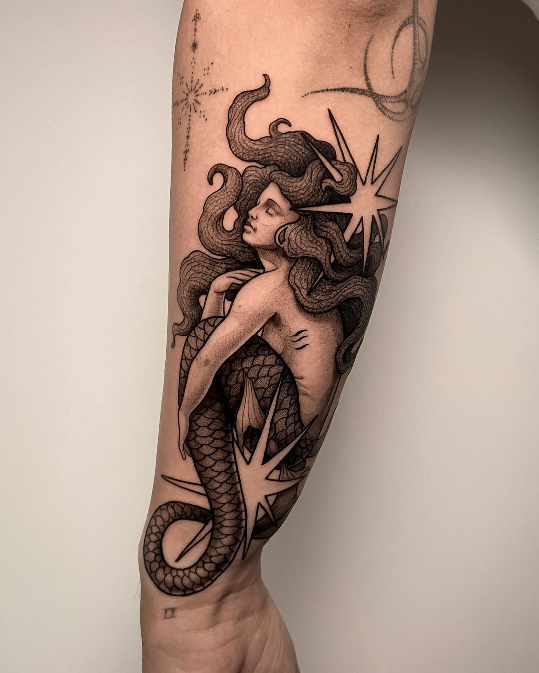 Elegant Mermaid Tattoo with Nautical Elements