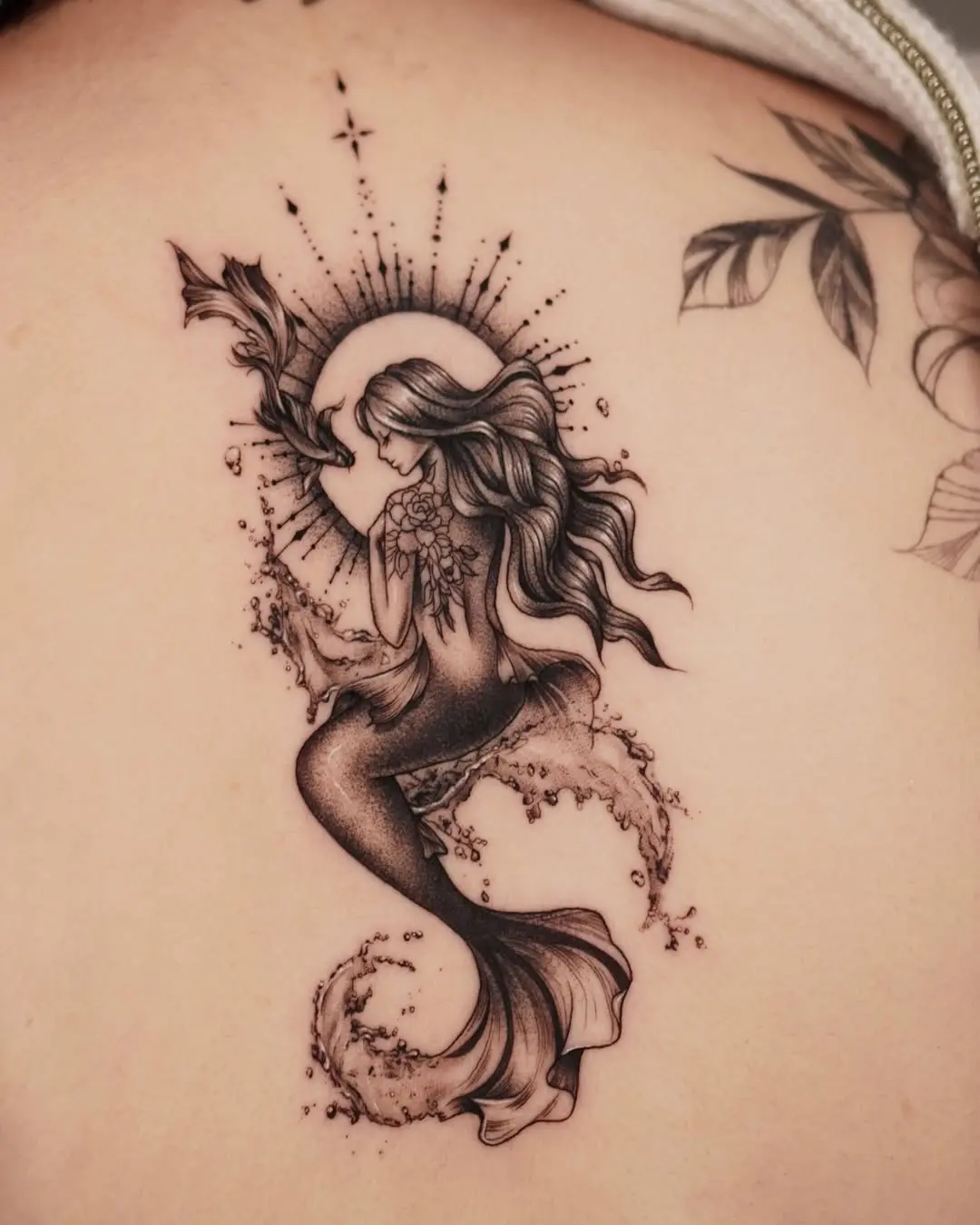 Elegant mermaid tattoo with celestial elements
