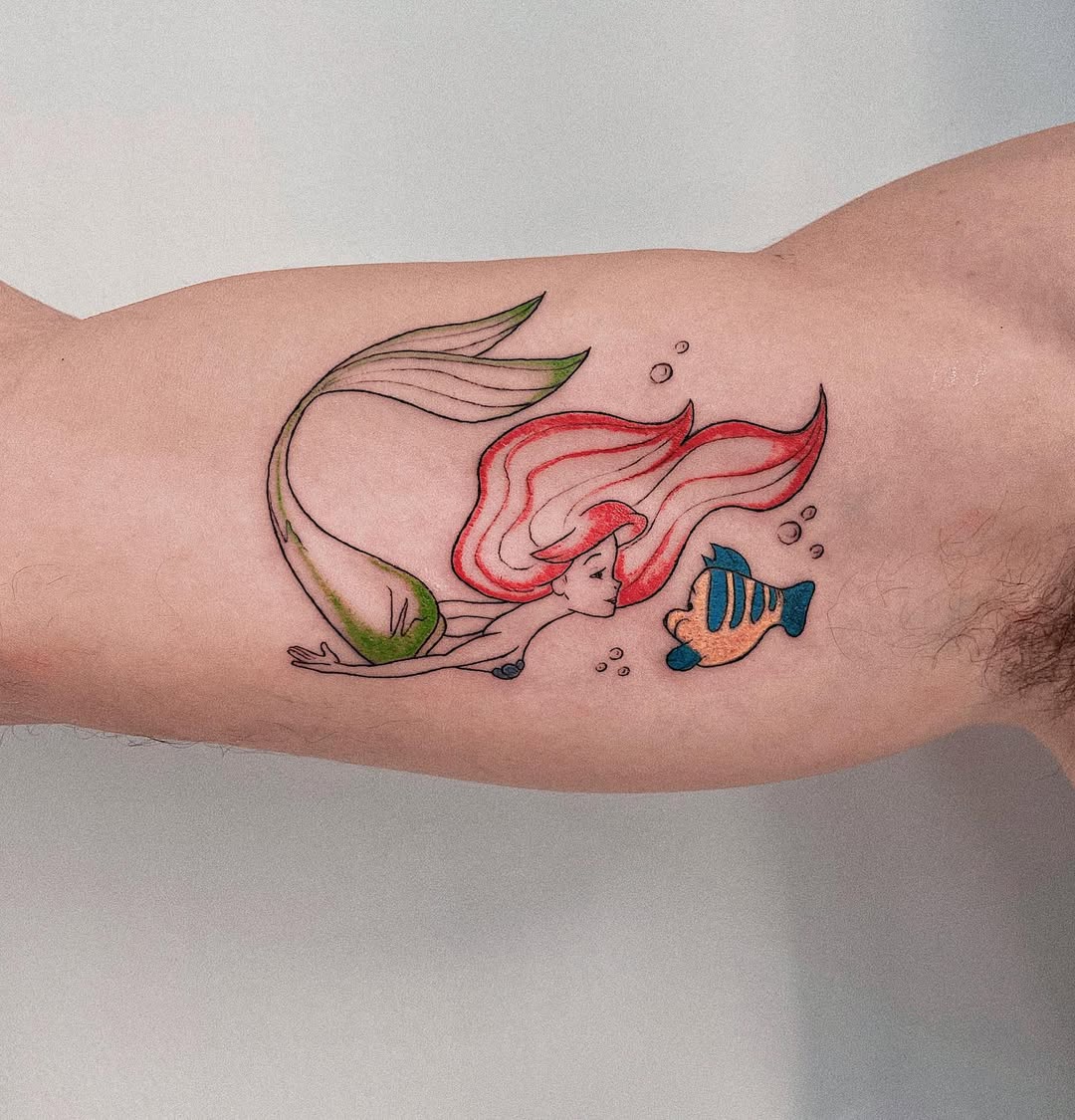 Vibrant Mermaid Tattoo with Playful Fish