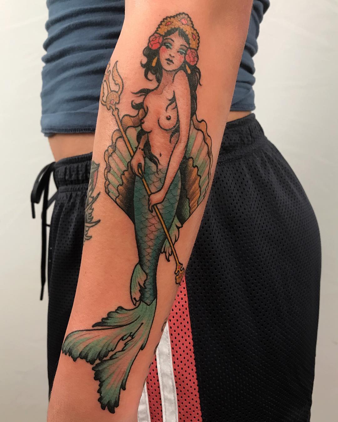 Elegant mermaid tattoo with vibrant watercolor hues