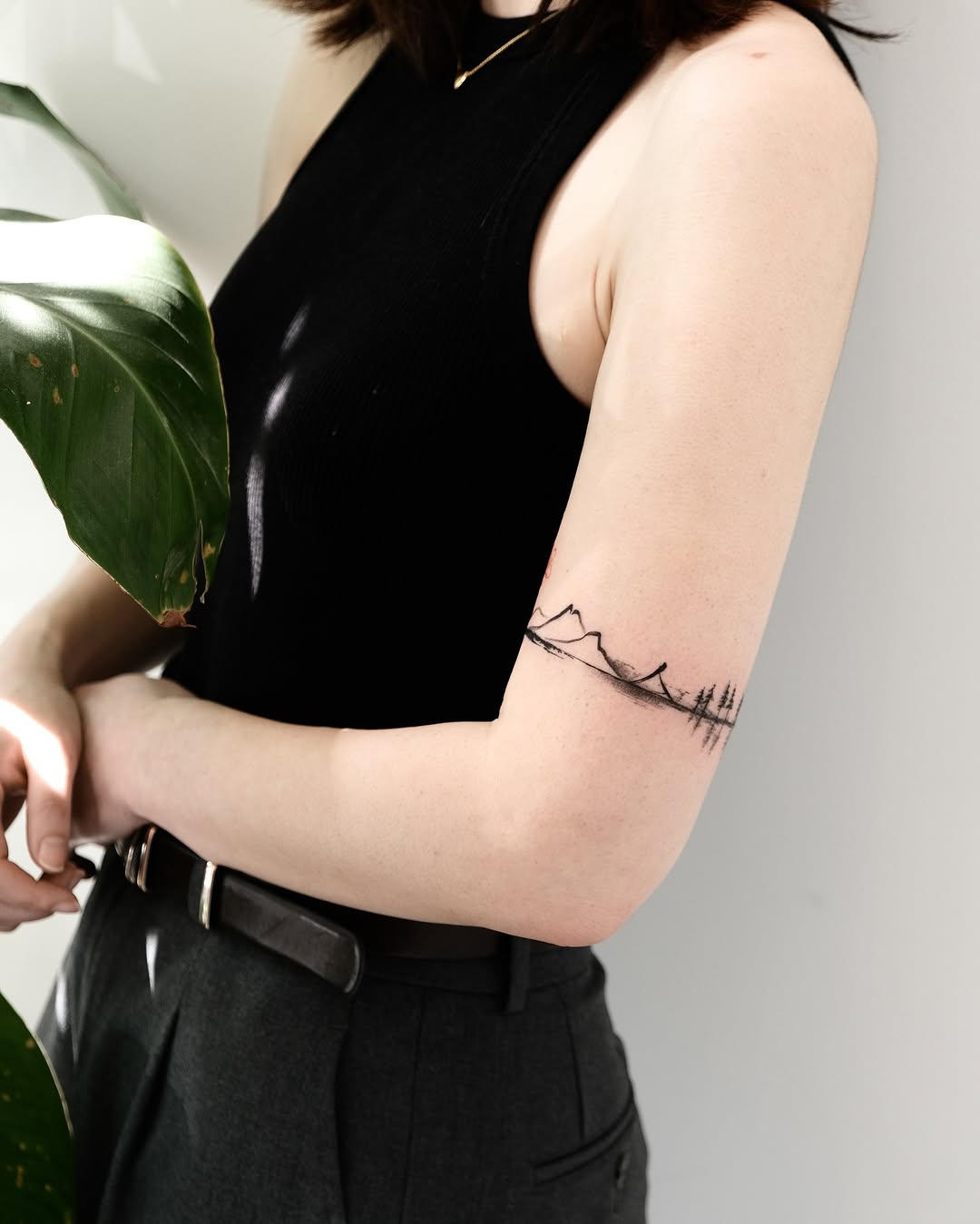 Elegant minimalist landscape tattoo on the arm