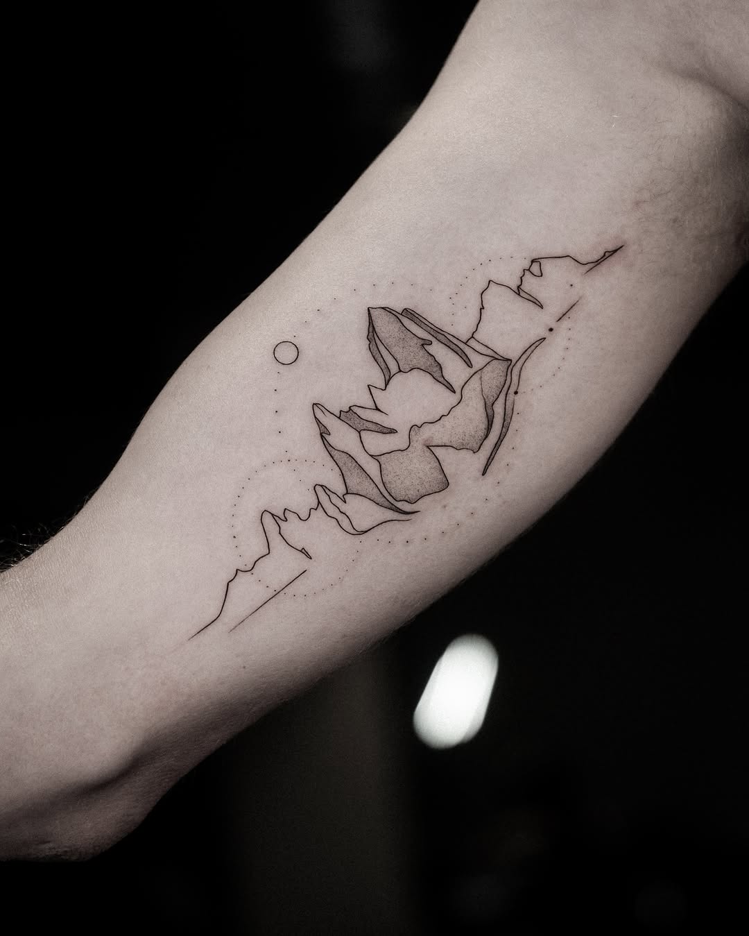 Sleek minimalist mountain tattoo design inspiration