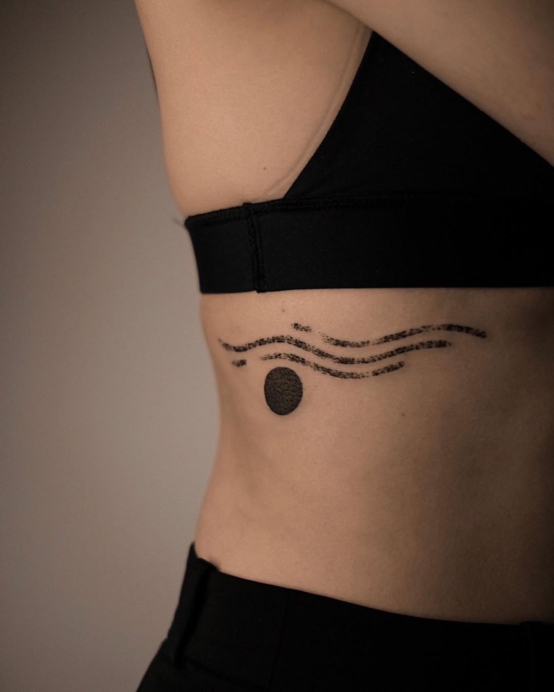 Elegant minimalist sun tattoo on the side