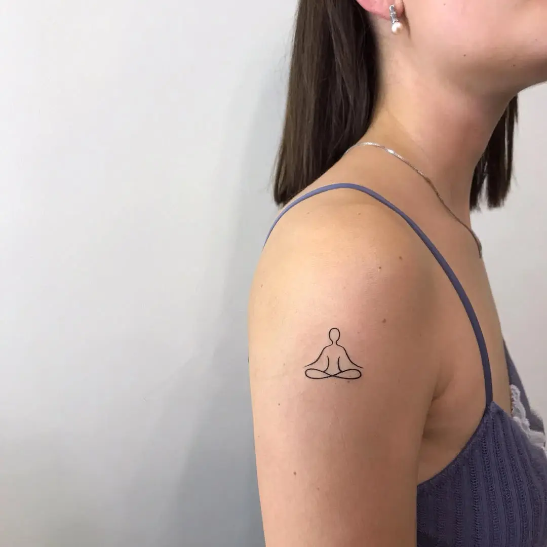 Elegant minimalist yoga pose tattoo on arm