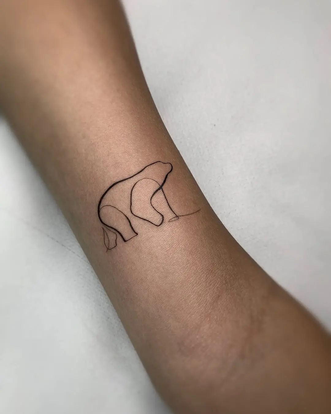 Elegant minimalistic bear tattoo design