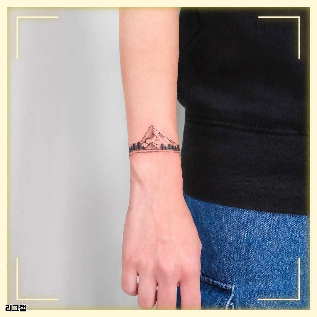 Trendy minimalistic mountain tattoo on wrist