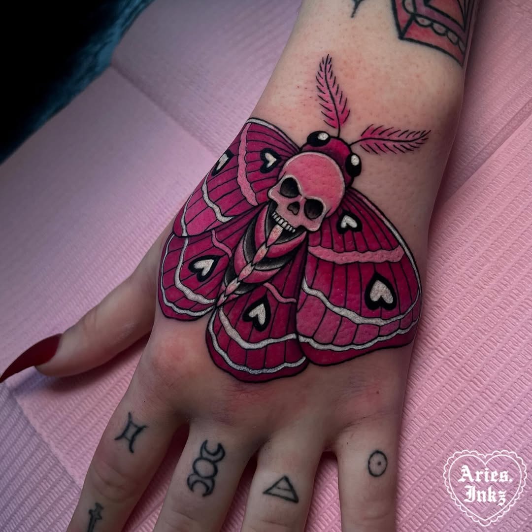 Bold moth tattoo with a skull twist