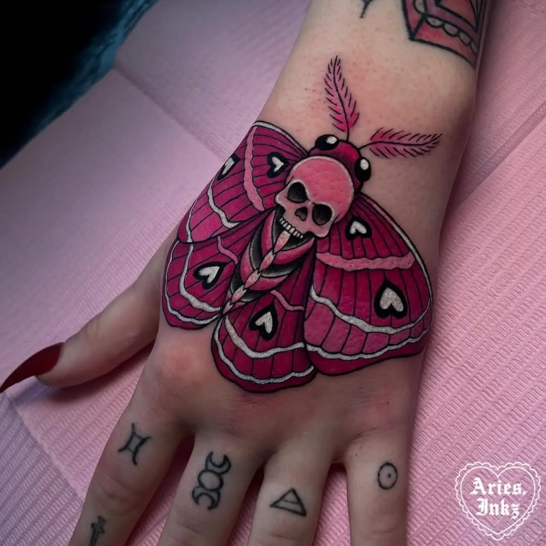 Bold moth tattoo with a skull twist