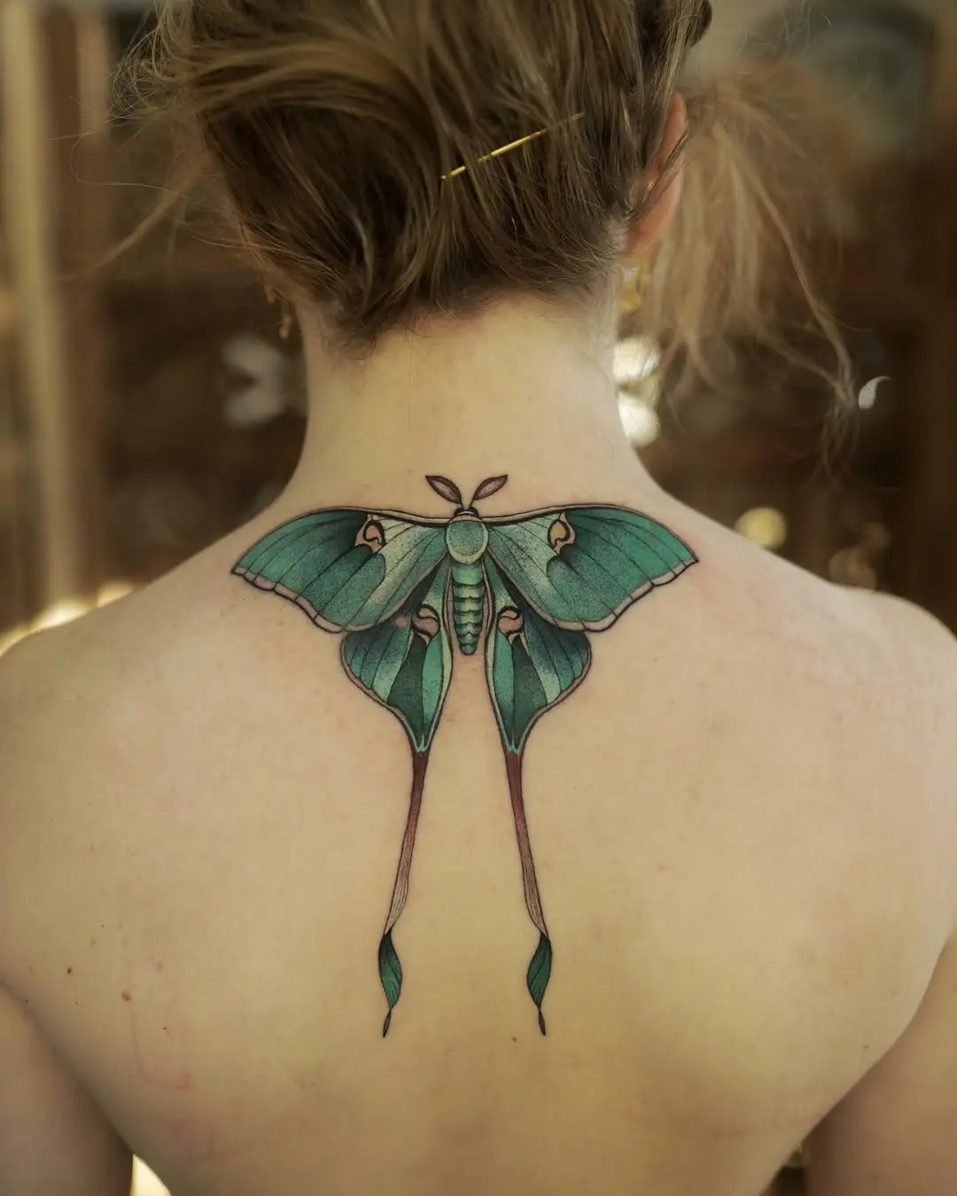 Stunning back moth tattoo with vibrant colors