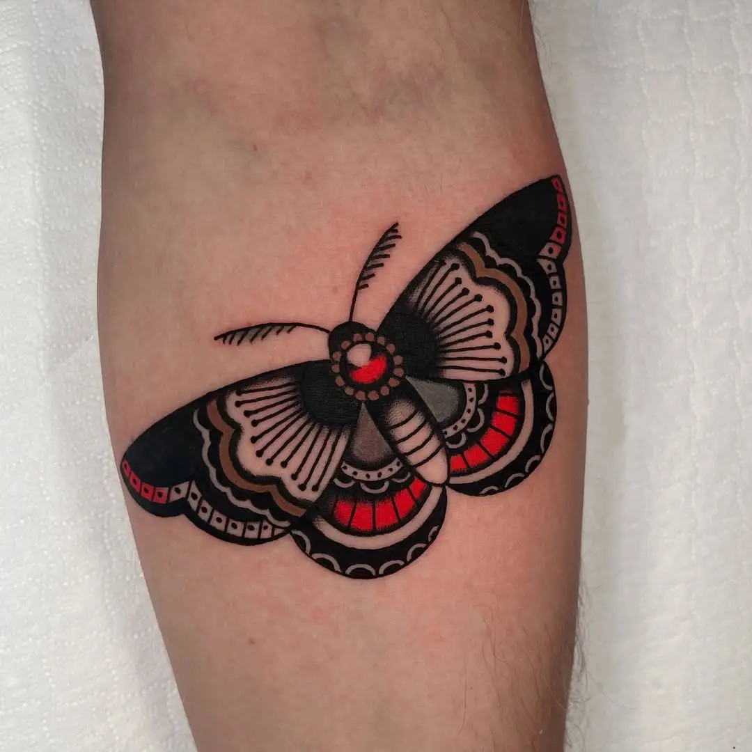 Bold black and red moth tattoo design