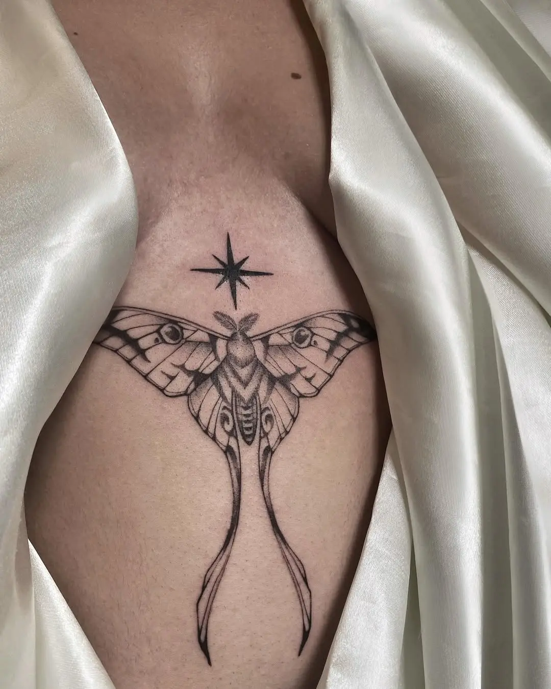 Elegant moth tattoo with celestial touch