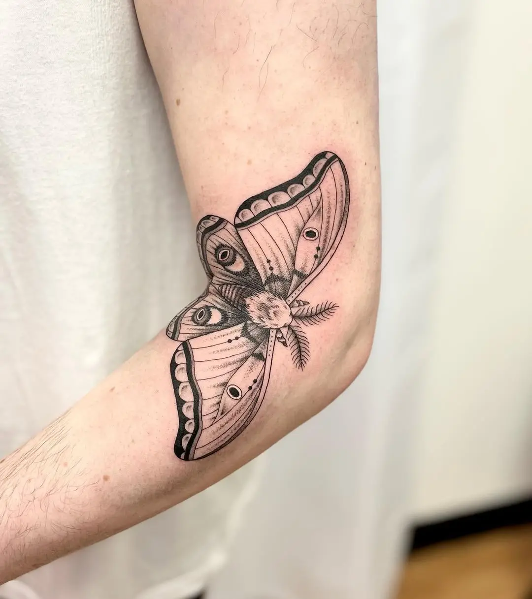 Stunning black and white moth tattoo on arm