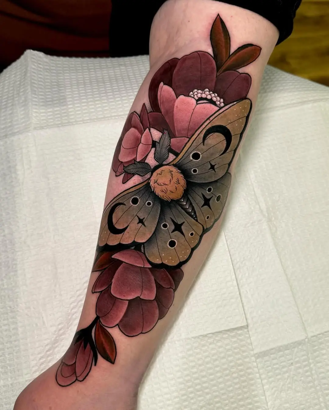 Stunning moth surrounded by vibrant flowers