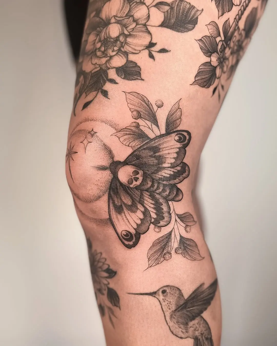 Intricate moth design with floral elements