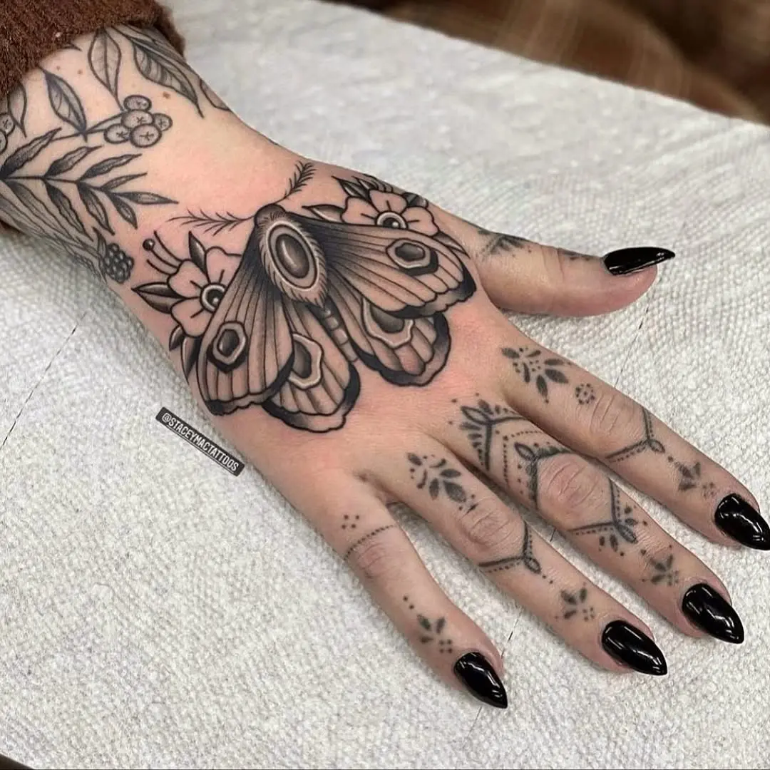 Elegant moth tattoo with floral details