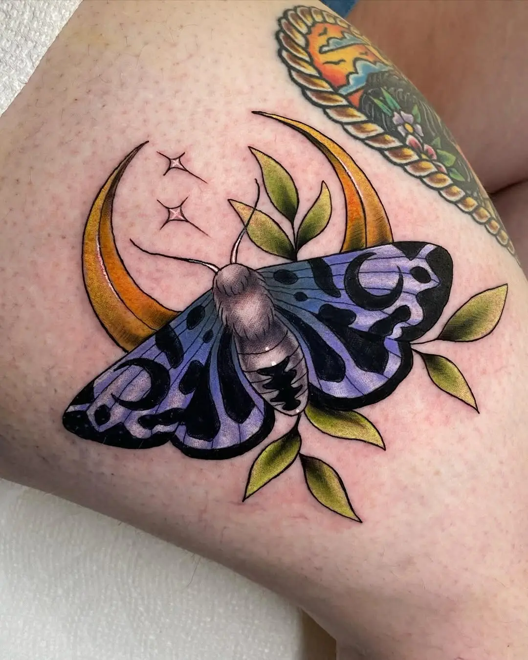 Elegant moth tattoo with celestial vibes