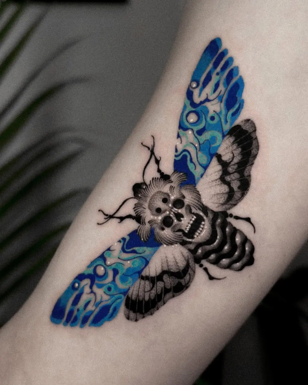 Stunning moth tattoo with black and blue hues