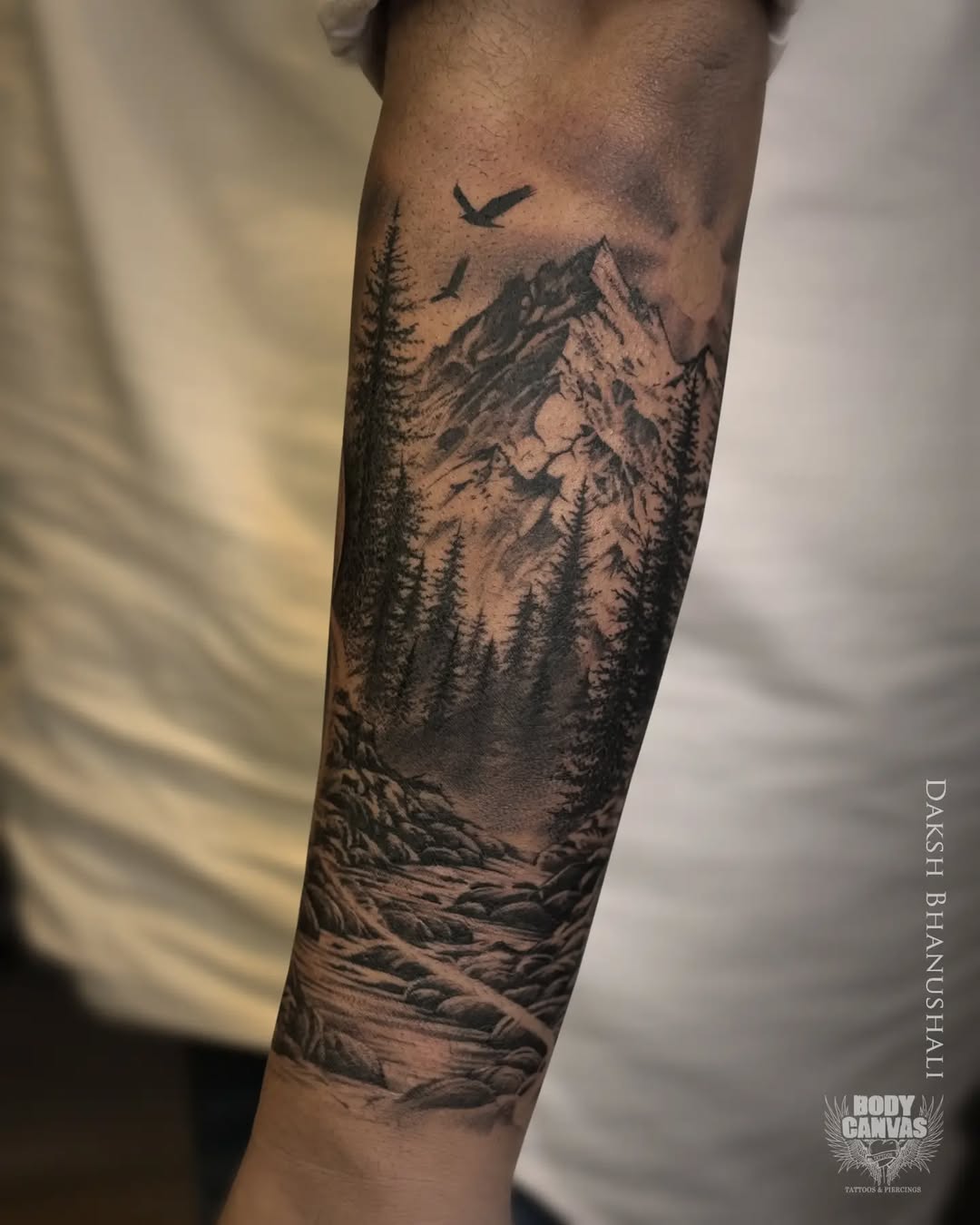 Intricate mountain tattoo with serene wilderness vibes