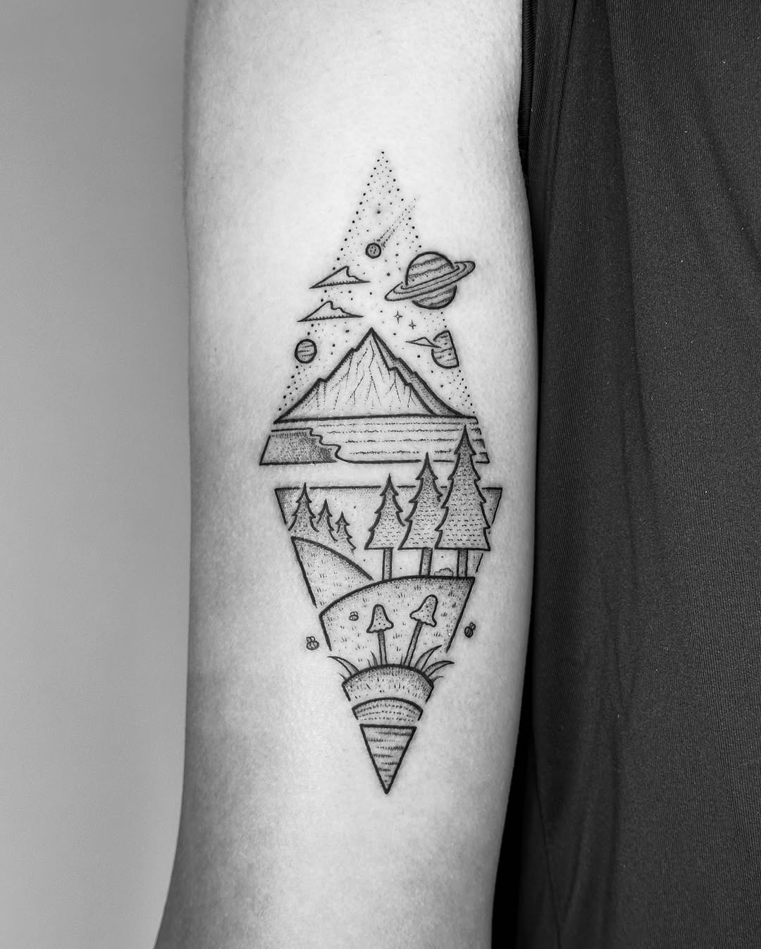 Stunning mountain tattoo with cosmic elements