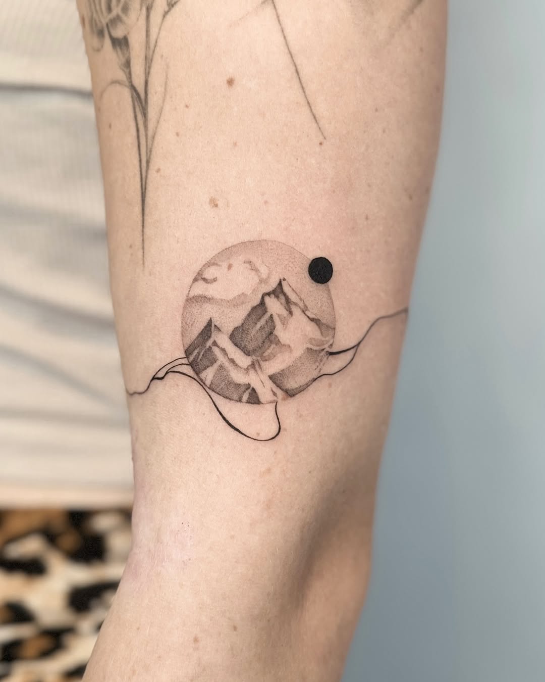 Unique minimalist mountain tattoo with celestial vibe