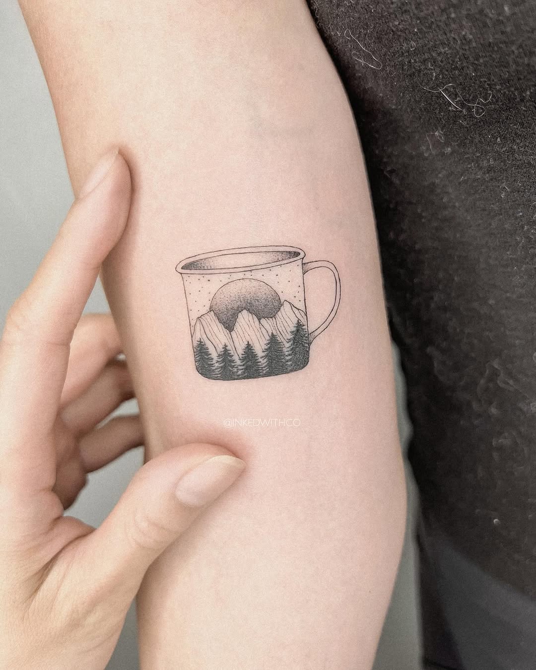 Whimsical mountain tattoo in a coffee cup