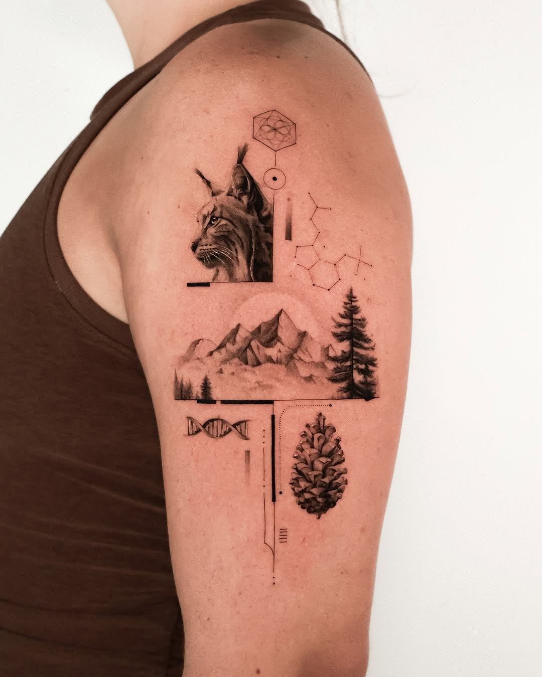 Intricate mountain and wildlife tattoo design.