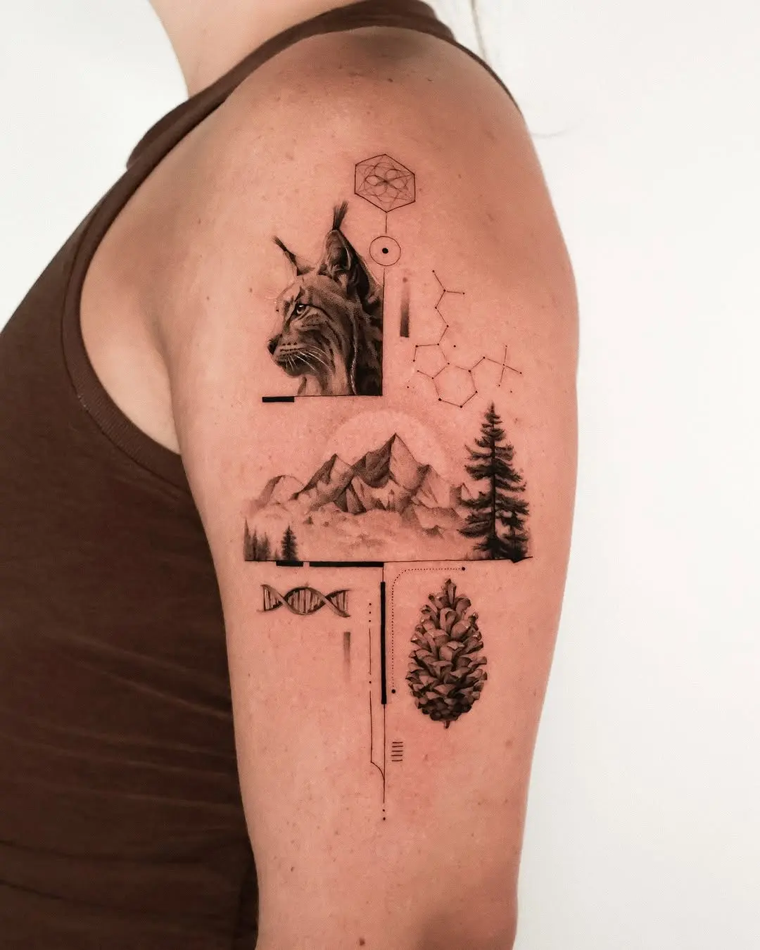 Intricate mountain and wildlife tattoo design.