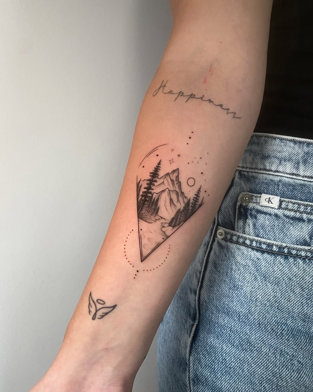 Minimalist Mountain Tattoo with Cosmic Elements